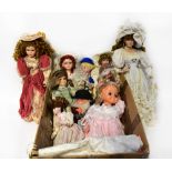 Ten mainly display dolls, some with stands, to include one in pink velvet Edwardian costume,