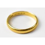 A 22ct gold wedding band, size T, approx 4.7g.