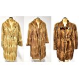 Three vintage fur coats comprising a camel-coloured coat with hook and eye fastenings and collar