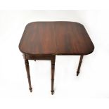A Victorian mahogany fold-over tea table with simple frieze and raised on turned supports,