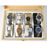 A wooden case containing eight dress watches, to include Casio, Citron Quartz, two Sekonda examples,