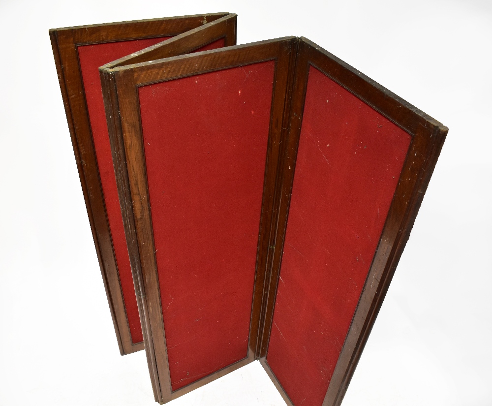 A late 19th century mahogany four-panel screen, each panel upholstered with a red felt material,