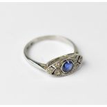 A platinum and 18ct white gold Art Deco style ring set with central blue stone flanked by three