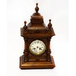 An early 20th century oak cased mantel clock of architectural form,
