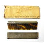 A George V hallmarked silver backed travelling comb the case with engine turned decoration,