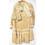 A Victorian Spring outfit comprising a long skirt and blouse in a fawn fabric, possibly silk,
