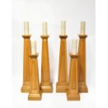 Six contemporary oak candlesticks of obelisk form, each with a fielded panel to each side,