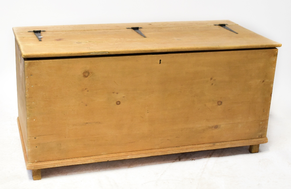 A very large, possibly bespoke made pine bedding box, the pine top with iron external hinges,