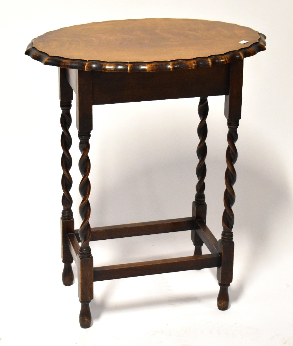 A reproduction oak sewing table, the shaped oval hinged lid opening to reveal a box section,