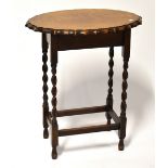 A reproduction oak sewing table, the shaped oval hinged lid opening to reveal a box section,