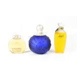 Three shop display factice perfume bottles comprising a 'Sun, Moon and Stars' blue perfume bottle,