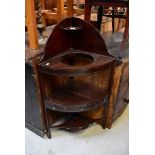 An Edwardian mahogany corner wash stand with curved splash back and small corner shelf,