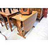 A good quality oak reproduction gateleg table of oval shape,