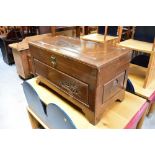 A mid-20th century Oriental-style camphor chest with figural and scenic carved decoration to top