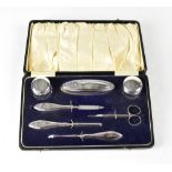 A cased George V hallmarked silver vanity set comprising nail buffer,