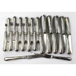 A set of twelve Edwardian silver-handled pastry knives and forks with rivet-effect decoration to