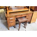 An early 20th century oak seven-drawer twin pedestal desk,