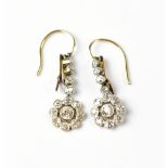 A pair of floral-set diamond drop earrings.