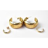 A pair of 9ct gold large wide hoop earrings with scroll decoration and a pair of small 3/4 hoop