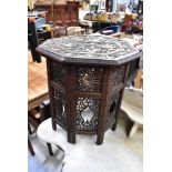 A late 19th/early 20th century Ottoman-style coffee table with carved octagonal top depicting a