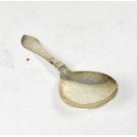 GEORG JENSEN; a silver caddy spoon with planished bowl and geometric motif to stem,