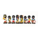 Eight Robertsons Golly band figures including band members and a lollipop man, height of largest 7.