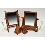 A Victorian mahogany swing toilet mirror on a scalloped base, together with one other toilet mirror,