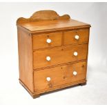 An early 20th century stripped pine wash stand with curved or shaped back,