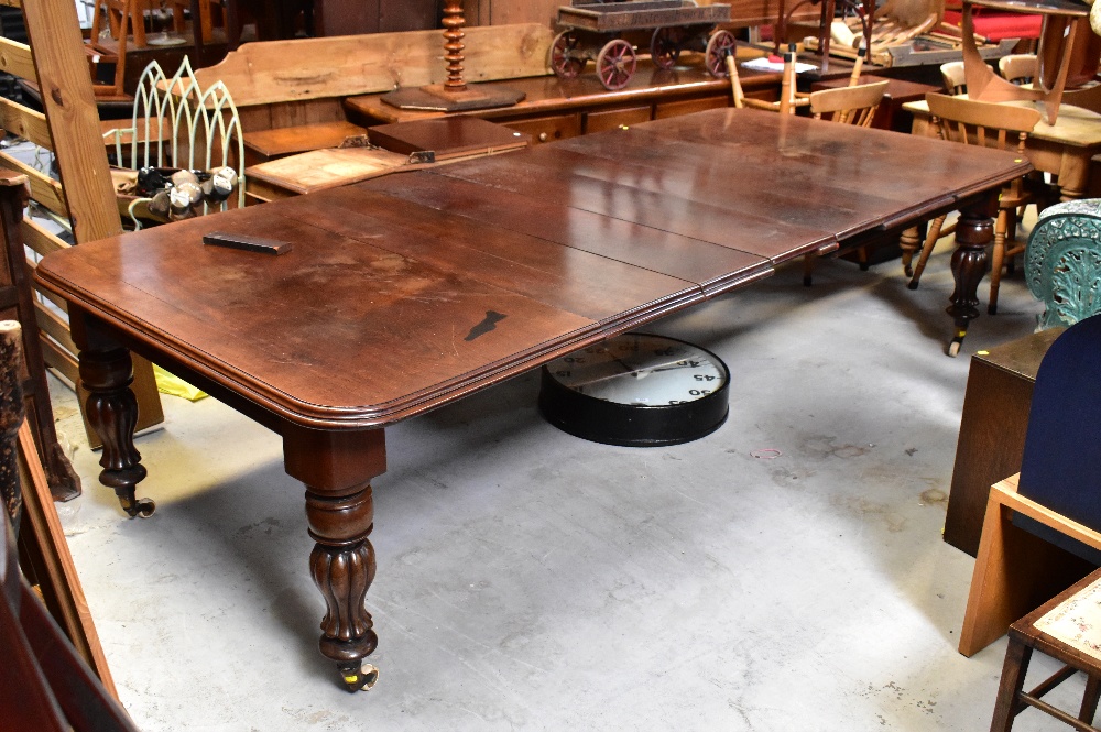 A large mahogany wind-out extending dining table, with six leaves,