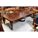 A large mahogany wind-out extending dining table, with six leaves,