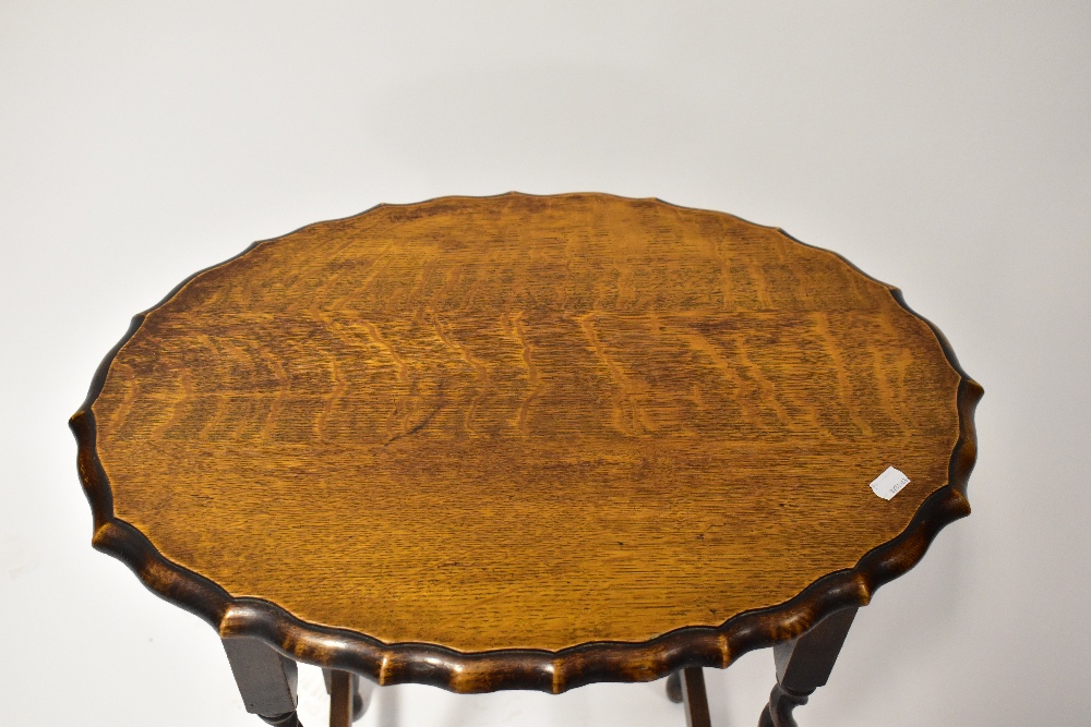 A reproduction oak sewing table, the shaped oval hinged lid opening to reveal a box section, - Image 2 of 3