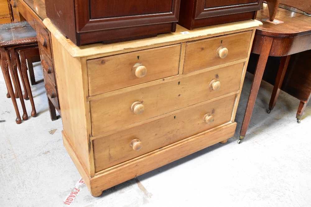 An early 20th century pine chest of two short over three long drawers,