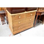 An early 20th century pine chest of two short over three long drawers,