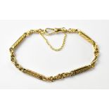 A 9ct gold Edwardian-style bar and hoop bracelet, with floral textured design and gold safety chain,