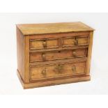 An early 20th century stripped pine chest of two short over two long graduated drawers,