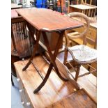 A mid-20th century folding table, the mahogany-effect rectangular top with canted corners,