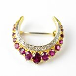 An 18ct yellow gold brooch set with rubies and diamonds, approx 10.7g.