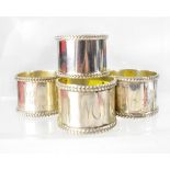 A group of five Elizabeth II hallmarked silver napkin rings, with rope-style edge to top and bottom,