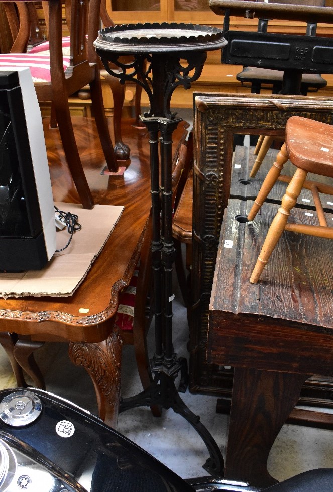 An ebonised Aesthetic Movement jardinière stand with dished top,