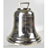 A 20th century silver inkwell in the form of a large bell with parcel gilt interior to lid,