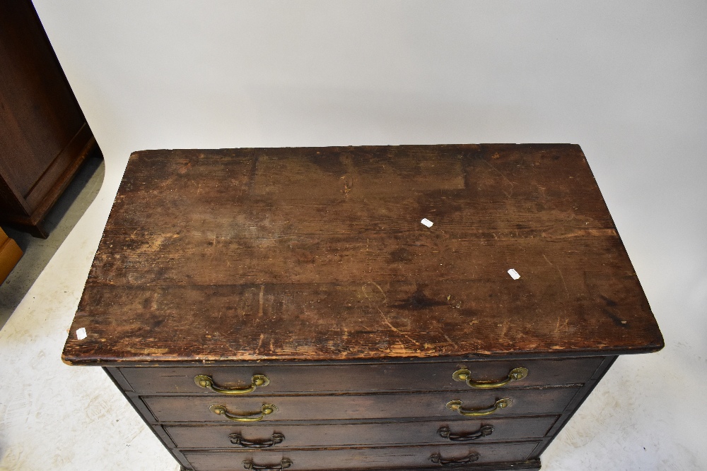 An early 20th century stained pine chest of four long drawers, to plinth base, raised on castors, - Image 2 of 3