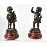 A pair of 20th century bronze putti/cherub figures, one depicting putti with bow, holding a heart,