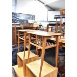 A pair of mid-20th century teak side tables, each with slatted undertier, on square tapering legs,