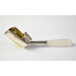 A late 19th century hallmarked silver scoop with gilt interior and floral decoration,