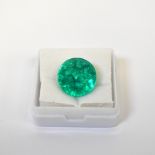 A loose 9.77 carat round emerald with GIL Laboratory Certificate.