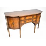 A reproduction mahogany bow-front sideboard, with pair of doors above arched alcove,