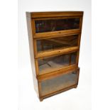 GLOBE-WERNICKE LTD; an oak four-section stacking breakfront bookcase,