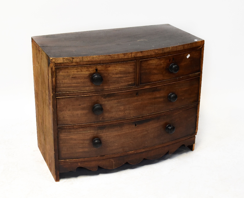 A Georgian mahogany bow-front chest of two short over two long drawers, above a shaped apron,