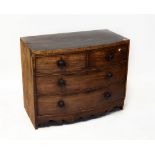 A Georgian mahogany bow-front chest of two short over two long drawers, above a shaped apron,