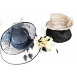Five vintage hat boxes each containing vintage straw hats in a variety of colours, black, cream,